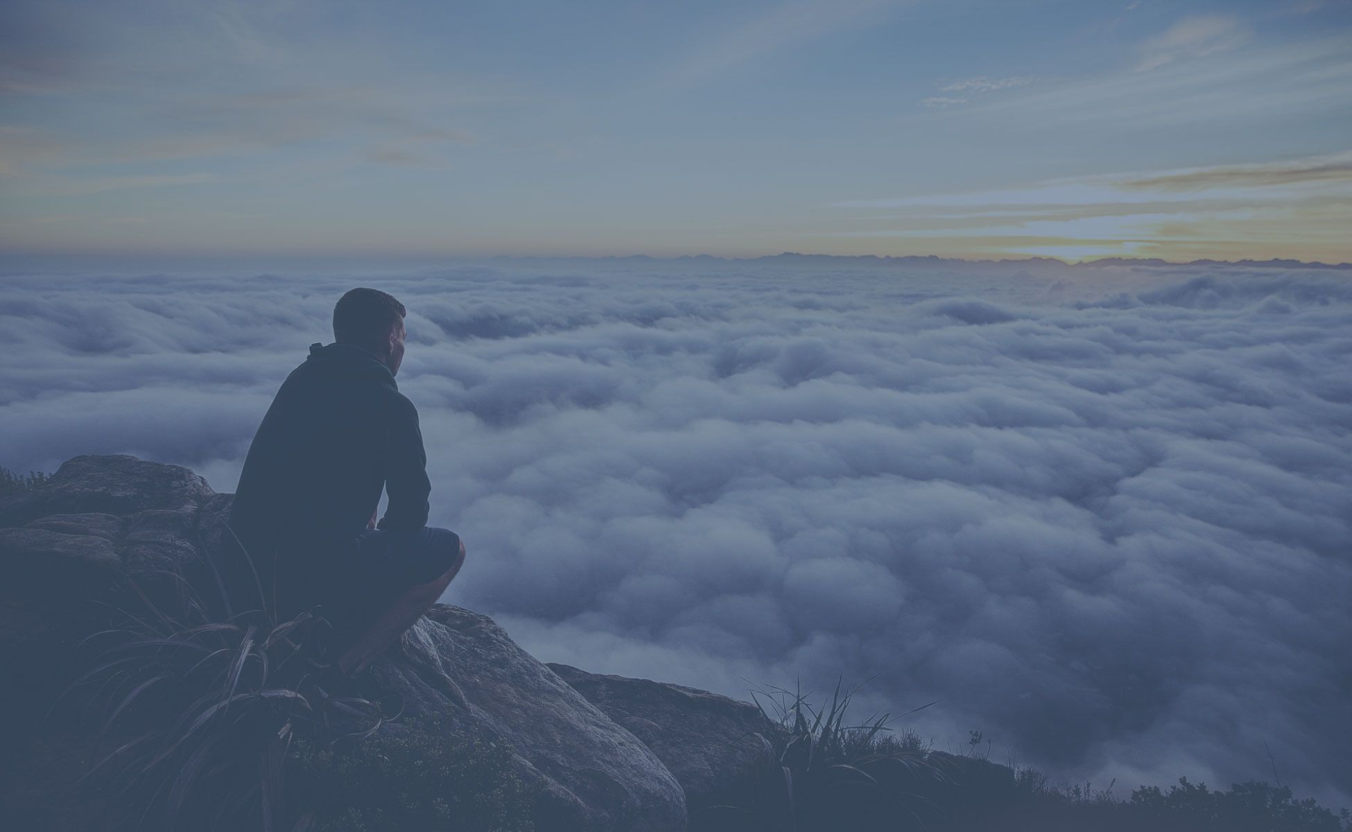 Person Sitting on a Mountain Top Person Sitting on a Mountain Top