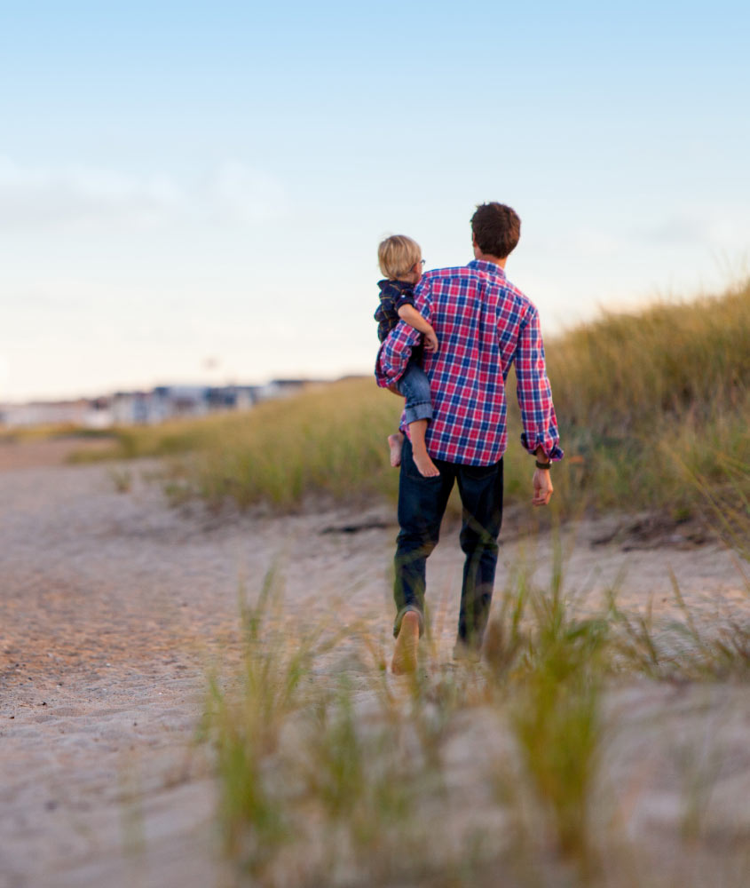 Man Walking With Child on Beach Man Walking with Child on Beach